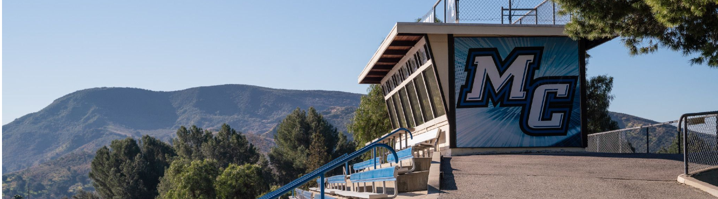 photo of Moorpark College logo on side of score booth with mountain in the background